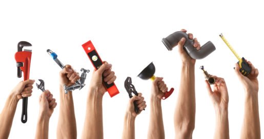 Set of male hands holding plumbing equipment on white background